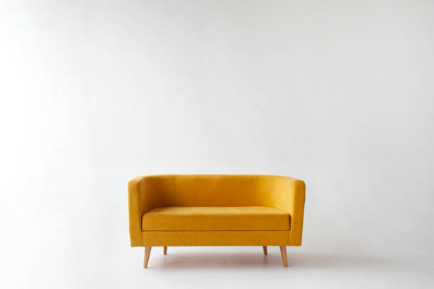 istock soft empty yellow sofa stands on white isolated background, comfortable fabric couch is alone against the white wall 1758454895