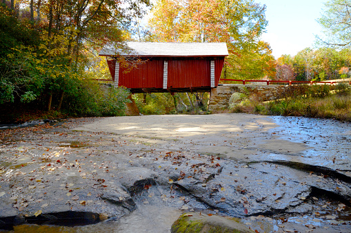 Autumn sugar maple frames Hectorsville covered bridge \nMontgomery, Vermont