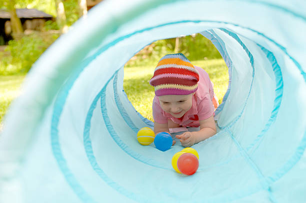 istock Baby playing inside a toy tunnel 175847594