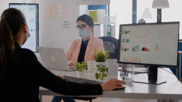 istock Business woman looking at financial graphs on computer display 1758483423