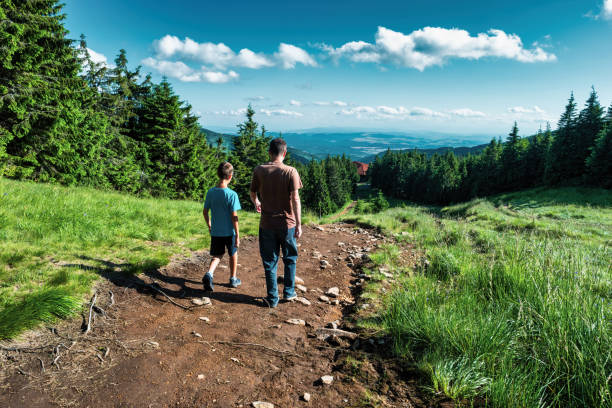 Father hiking with son in a forest, Harghita Mountains, Carpathians, Transylvania, Romania.