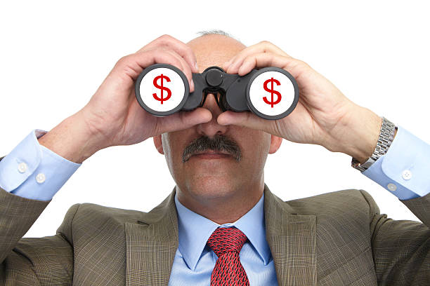 istock Dollar. The businessman and binoculars 175850940