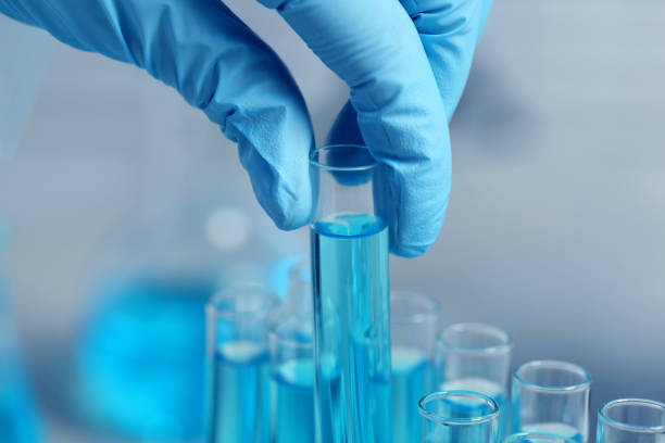 istock Scientist taking test tube with light blue liquid on blurred background, closeup 1758512762
