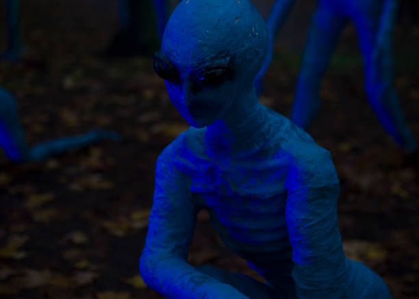 istock Halloween decoration, bright blue aliens on dark night background 1758528867