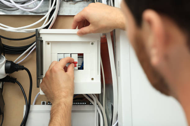 istock Electrician switching off circuit breakers in fuse box, closeup 1758531121