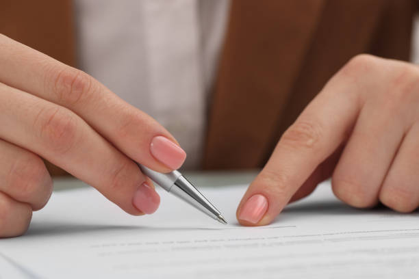 istock Woman signing document at table, closeup view 1758531646