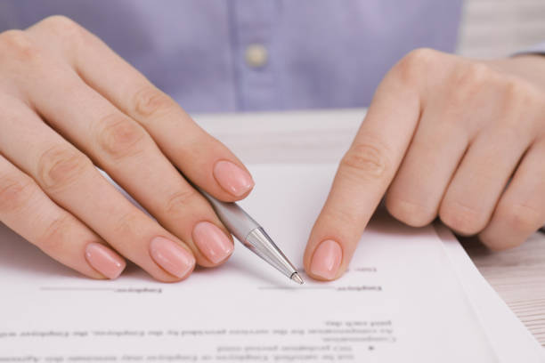 istock Woman signing document at table, closeup view 1758531653