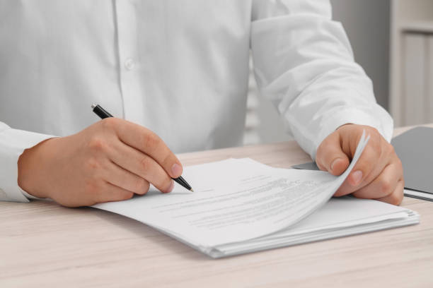 istock Man signing document at wooden table, closeup 1758531961