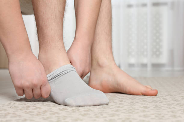istock Man putting on light socks at home, closeup 1758534299