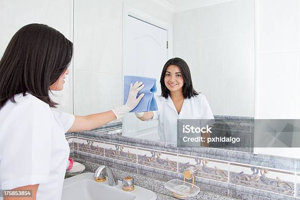 Pretty Woman Cleans Mirror In Bathroom At Home Stock Photo - Download Image Now - Adult, Beautiful People, Beauty