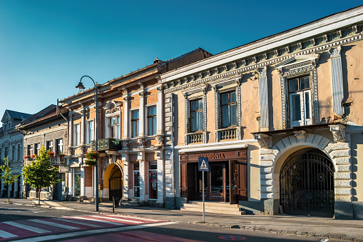 Ornate facades in downtown Odorheiu Secuiesc (Szekelyudvarhely) in Transylvania, Romania on a sunny day.