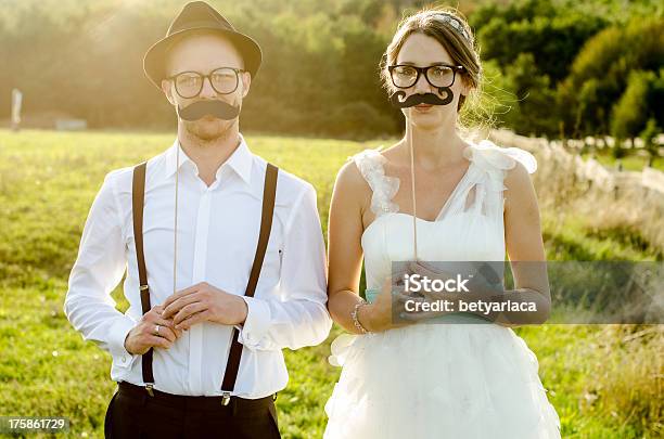 A Newlywed Couple Poses With Fake Mustaches And Glasses Stock Photo - Download Image Now