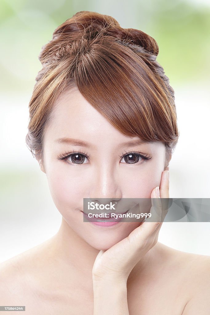woman with beauty face and perfect skin portrait of the woman with beauty face and perfect skin isolated on green background, asian model Adult Stock Photo
