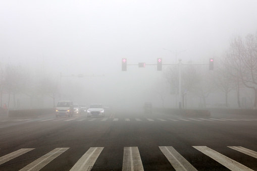 LUANNAN COUNTY, Hebei Province, China - March 10, 2020: The car walked slowly in the fog.