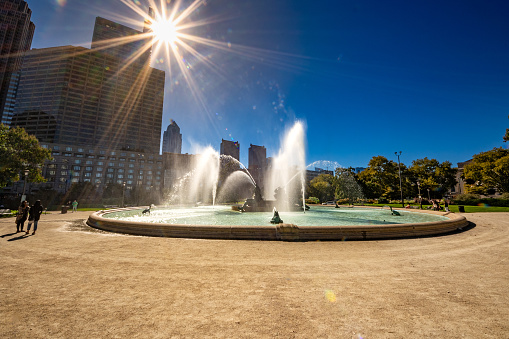 Philadelphia, PA - US - Oct 13, 2023 Wide angle view of Logan Square, a traffic circle center with a large fountain with whimsical statuary and garden areas with benches.