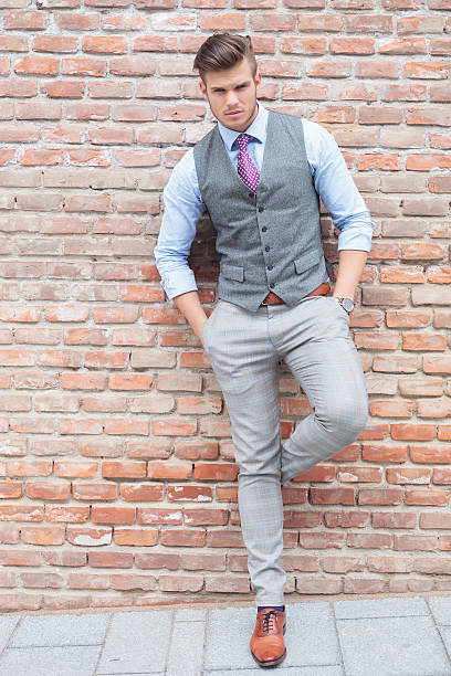 istock casual man leans on wall and looks at camera 175869035