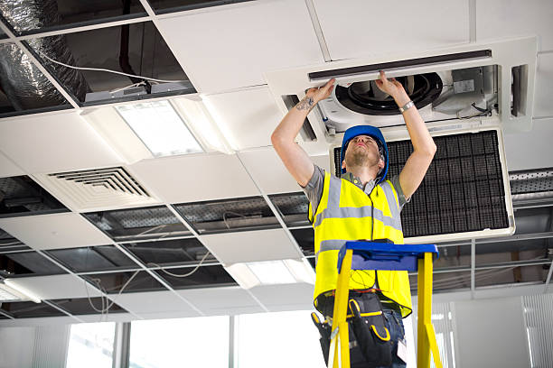 istock electrician fitting air conditioning to office interior 175869809