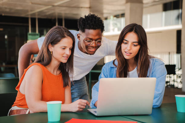 istock Group of multiracial happy teenage students using laptop, working on university assignment homework project in college library. Meeting of diverse young people looking information on computer 1758717646
