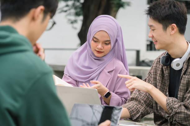 istock Diverse group of university students working together outdoors on campus. 1758754488