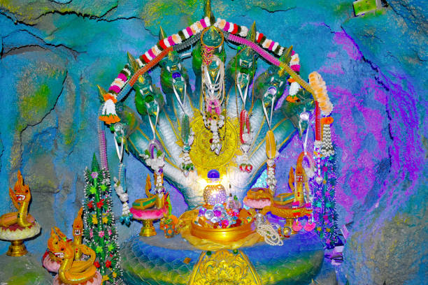 wat sawat niwet, magic cave, Phrae, Northwest Thailand, seven heads of a snake, different things hang from the heads, lots of floral decorations, artwork, crafts, attraction, point of interest