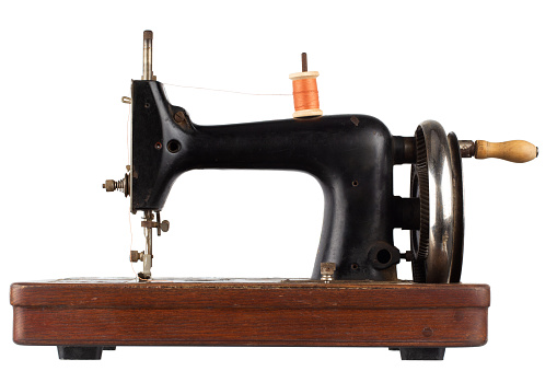 Retro vintage sewing machine isolated on white.