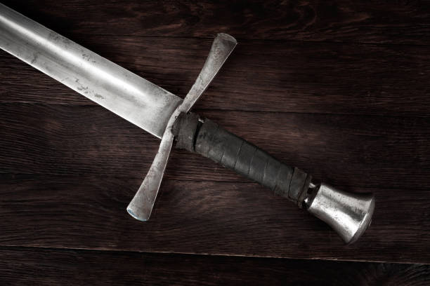 istock Medieval sword on wooden background. 1758806683