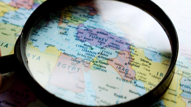 Using a magnifying glass, showing a close-up of the countries in the Middle East such as Israel, Egypt, Iraq, Iran, Lebanon, Jordan, Kuwait, Saudi Arabia, and many  more.