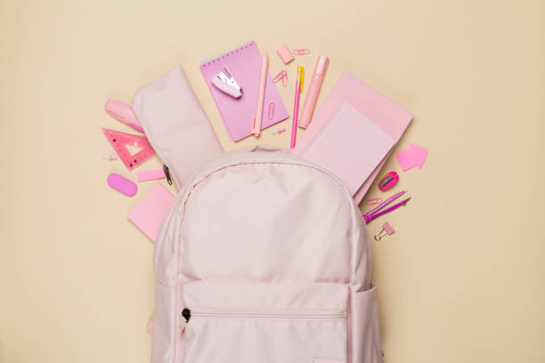 istock Pink school backpack with stationery on color background, top view 1758811281