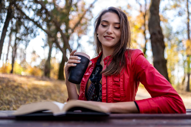 istock Relaxed woman reading a book in autumn day. 1758813047