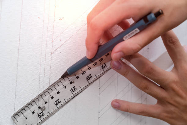 istock hand holding ruler and clutch-type pencil with canvas background 1758839668