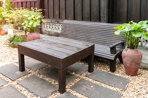 Black brown wooden table and bench in the garden