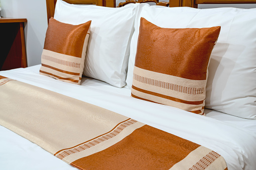Brown pillows on wooden bed