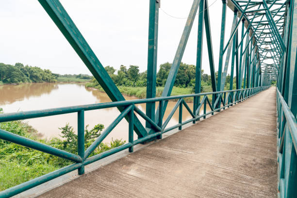 istock Green iron bridge across the river 1758853246