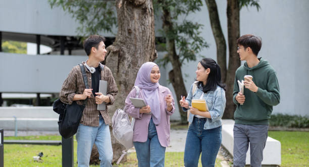 istock Student friendship concept with multiracial diverse classmate friend sitting together at campus college park. Millennial people having fun social gathering outside. Youth teenage and education 1758887277