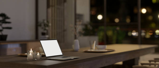 istock A white-screen laptop mockup on a dining table in a modern, minimal Japanese dining room style. 1758898278