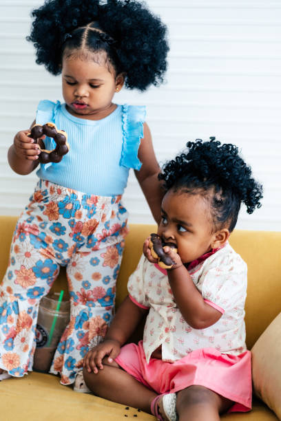 istock Mixed race baby girl eating doughnut 1758922518