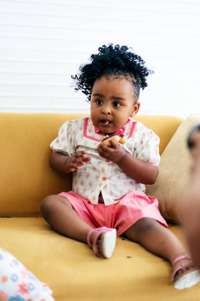 istock Mixed race baby girl eating doughnut 1758922527