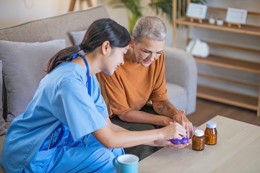 Nurse talks with senior patient about medication. and gives a recommendation to a senior female patient explaining medication.
