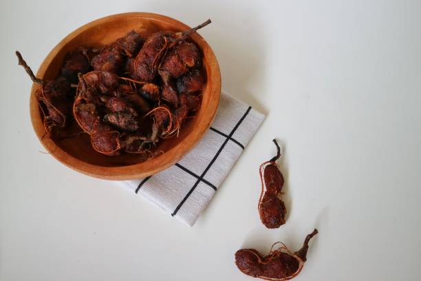 Ripe tamarind or asam jawa isolated on white background.