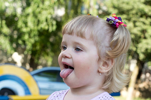 istock little girl shows tongue 175893968