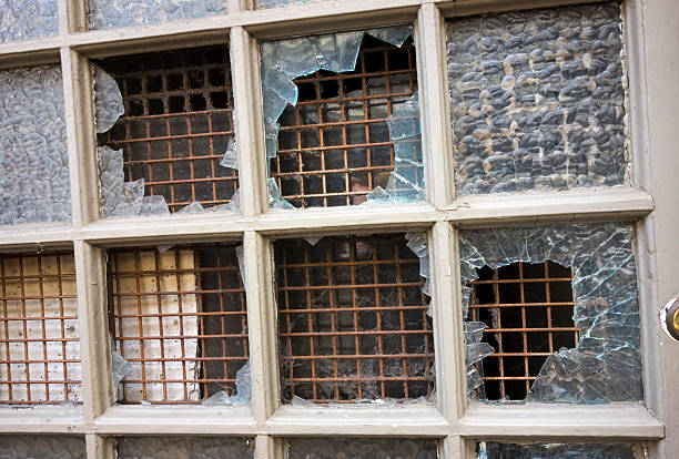 istock Vandalized glass pained windows of run down building 175894006