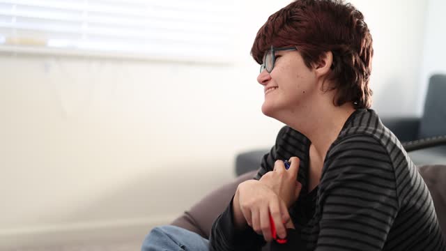 A Young woman with intellectual disabilities playing a video game