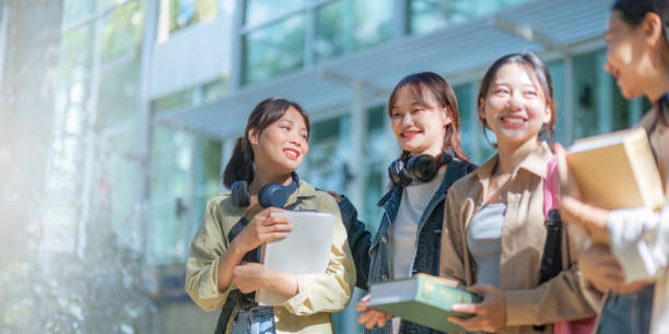 istock Student university friendship concept with classmate walking together at campus college park. Youth teenage and education 1758992191