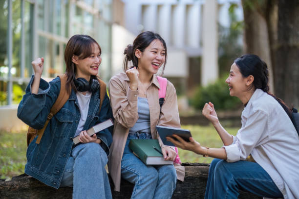 istock Student university friendship concept with classmate sitting together at campus college park. Youth teenage and education 1758992256