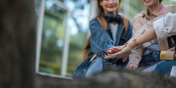 Student university friendship concept with classmate sitting together at campus college park. Youth teenage and education