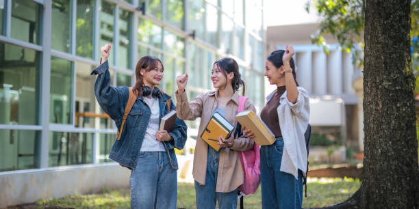 istock Student university friendship concept with classmate walking together at campus college park. Youth teenage and education 1758992321