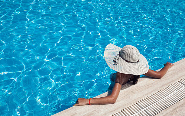 istock Woman with hat relaxing by the pool 175899735