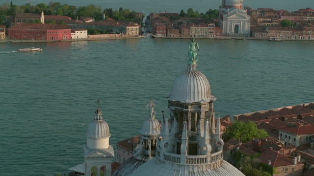 Aerial view of the dome of the Basilica di Santa Maria della Salute in Venice, Italy in sunshine. 4K