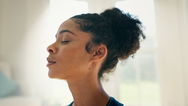 Face, yoga and meditation with a woman breathing closeup in her home for fitness, mindfulness or awareness. Exercise, zen or relax with a young person in an apartment for health, wellness or peace
