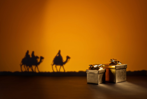 Three wise men on the way to Jesus in Bethlehem and presents